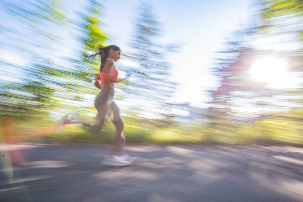 istock Athletic woman jogging during sunny day in forest 1336493434