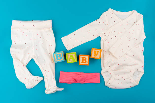 istock baby clothes on blue background top view 1336493435
