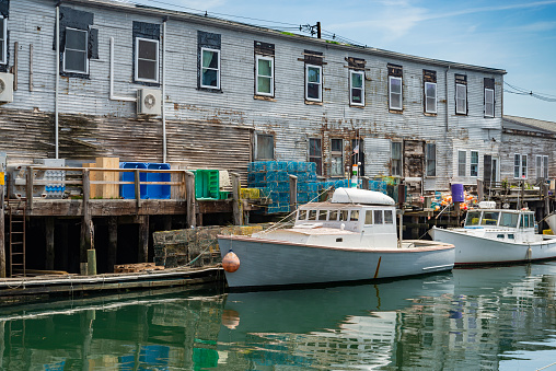 A pier filled with lobster traps and an old building, old port, in Portland, Maine. USA