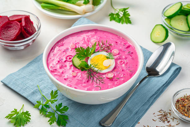 istock Cold beetroot soup with cucumber, egg and fresh herbs on a gray background 1336497276