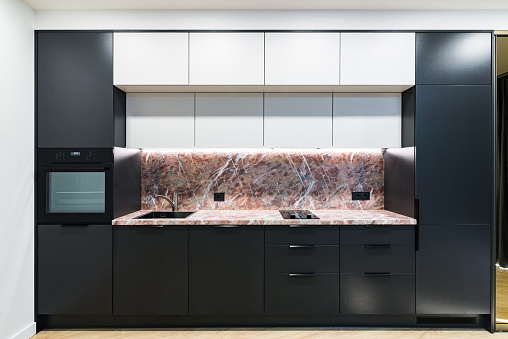 Modern black and white kitchen with marble counter, matte finish, new.