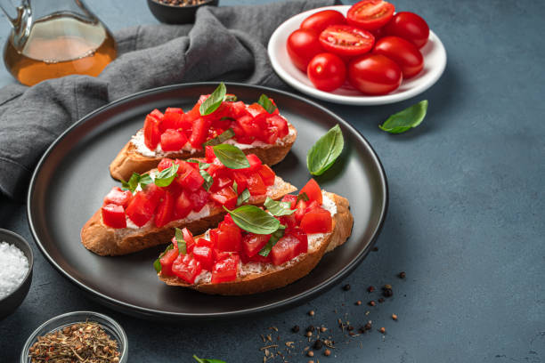 istock Italian bruschetta with tomato, basil and cheese on a gray-blue background 1336502857