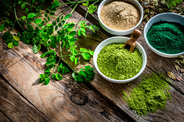 istock Spirulina, Maca and Moringa powders on wooden table 1336503128