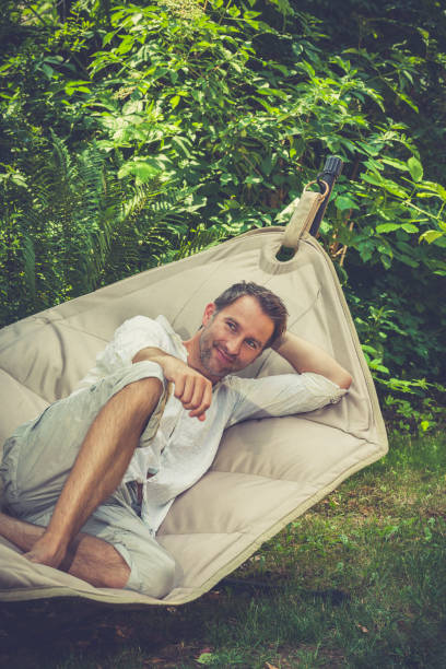 istock mid aged man chilling out in the hammock 1336503897