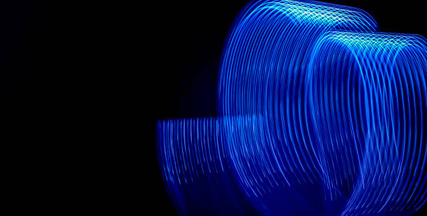 istock Beautiful graphic spiral blue light shapes on black background. Graphic background picture 1336504829