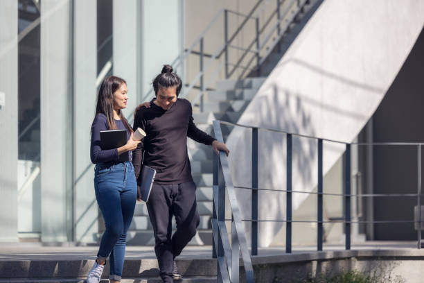 Students walk the stairways on campus, a couple walking down into the ground for extra education.