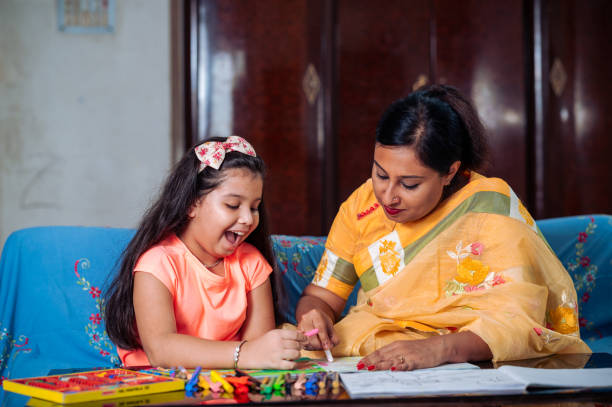 istock Mother Helping Her Daughter While Studying at home. 1336508774