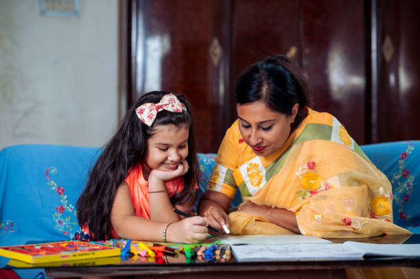 istock Mother Helping Her Daughter While Studying at home. 1336508775