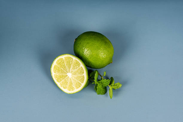 istock Green lemon and mint on a blue cyan background 1336508823
