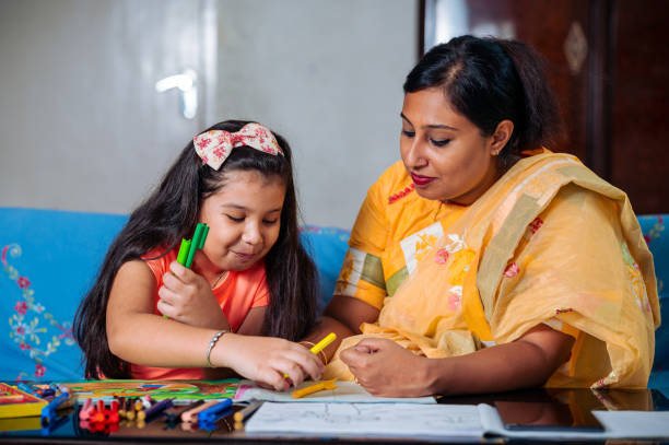 istock Mother Helping Her Daughter While Studying at home. 1336508958