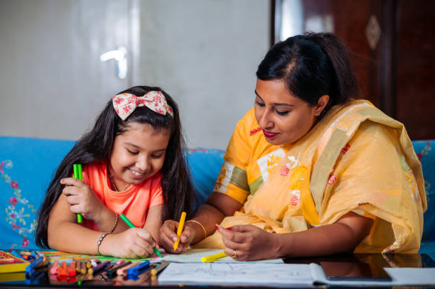 istock Mother Helping Her Daughter While Studying at home. 1336508976