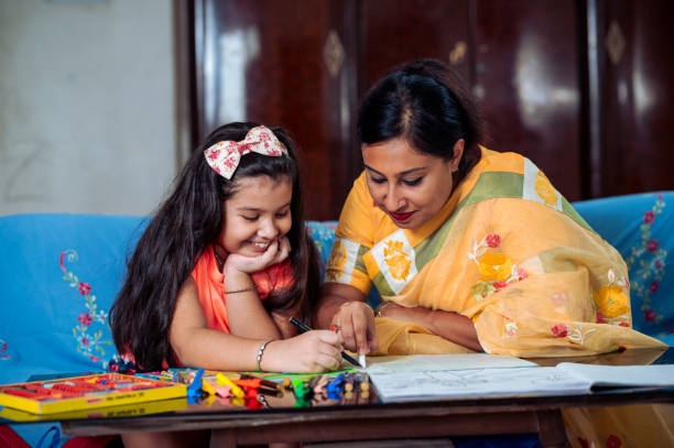 istock Mother Helping Her Daughter While Studying at home. 1336509053
