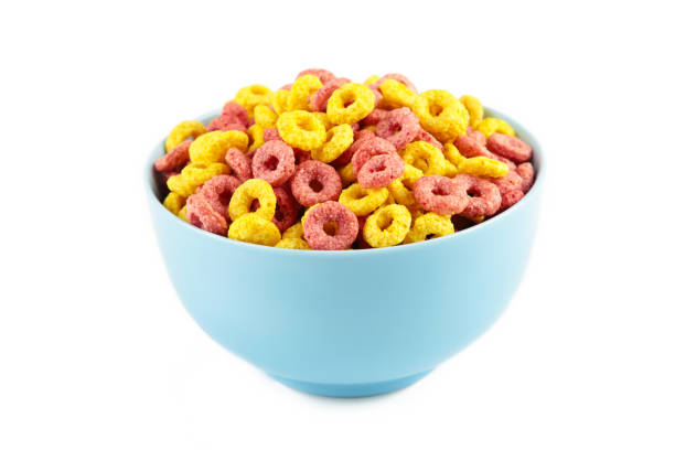 istock Colorful cereal loop rings on blue bowl isolated on white background. Breakfast food. 1336511476