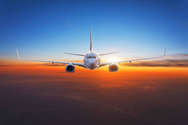 istock Dawn is high in the sky, the plane flies exactly in the frame. 1336511571