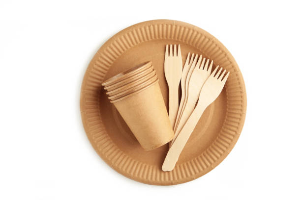 istock Eco - friendly plate with fork and glasses isolated on white background. Disposable tableware 1336512720