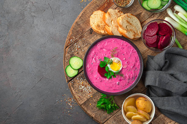 istock Beetroot soup on a dark background. Cold vegetarian dish of beetroot, potatoes, cucumbers, eggs, green onions, dill and parsley with kefir or sour cream 1336512786