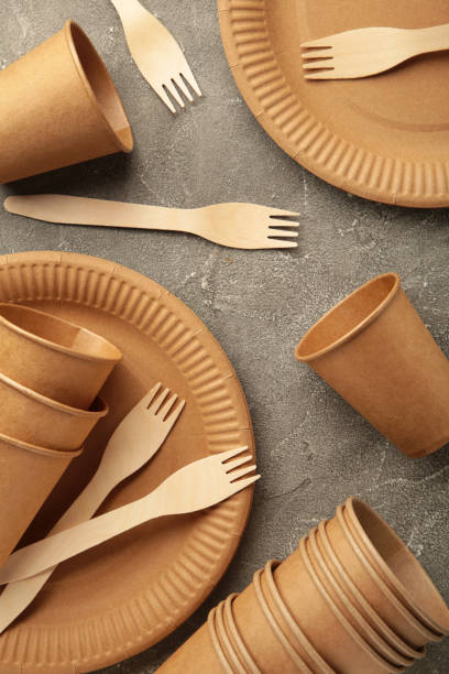 istock Eco friendly disposable tableware on a grey background. Vertical photo 1336513470