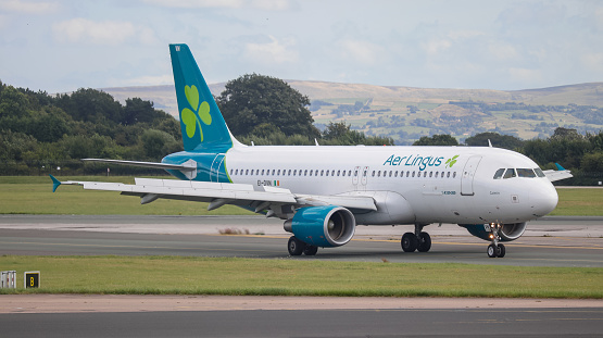Manchester, United Kingdom - August 13, 2021: Aer Lingus Airbus 320 (EI-DVN) taxiing to gate after landing at Manchester Airport.