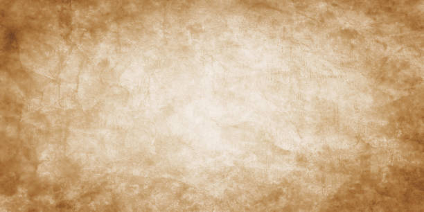brown paper parchment background design with old distressed vintage grunge on borders of dark sepia ink stains with white faded shabby center, elegant antique beige color stock photo