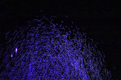Water Sprinklers go off at night illuminating the droplets as gravity applies its pressure. Original shot has been hue'd from yellow (street light) to select neon colors. Sorry Im red green color blind this one i can't decipher so it gets both.