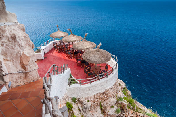 Cliff-top bar in Menorca overlooking the Mediterranean Sea Cliff-top bar in Menorca overlooking the Mediterranean Sea minorca photos stock pictures, royalty-free photos & images