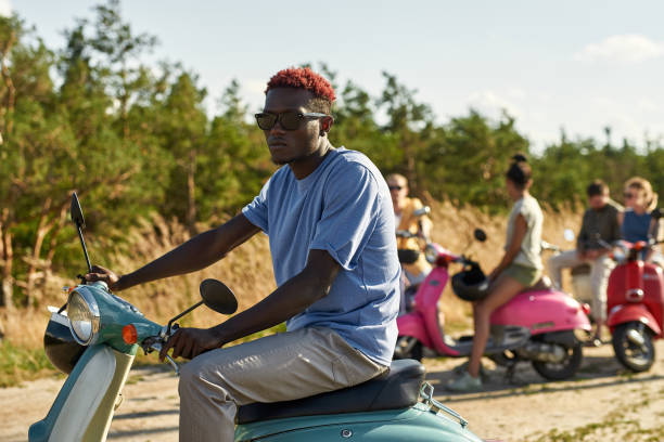 istock Handsome young african american man on retro scooter 1336516473
