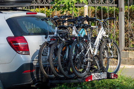 Petrozavodsk, Russia - 18 July 2021. four bicycles on a bike carrier on the towbar.