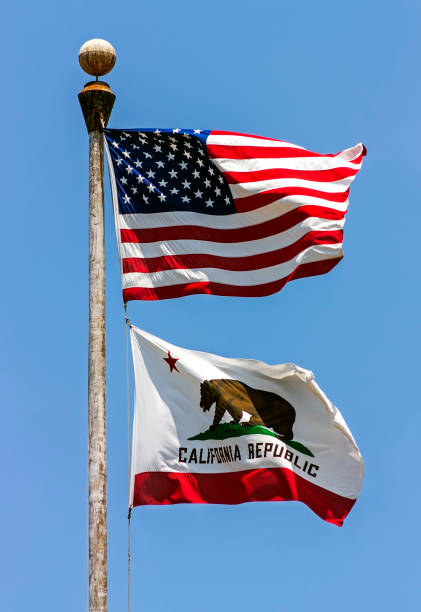 State flag of California - United States of America on blue sky.