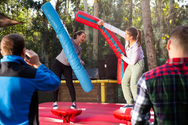 istock Female friends fighting by inflatable logs 1336519725