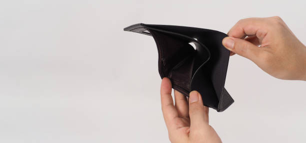 istock Hand is holding and open black empty wallet isolated on white background. 1336519784
