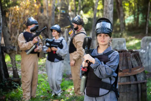 Photo of Portrait of young woman paintball player