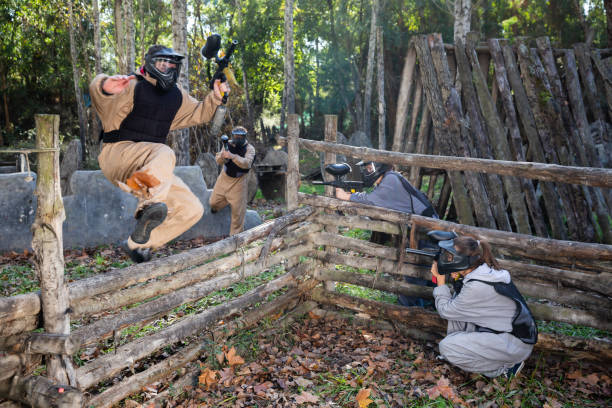 istock Paintball players shooting with guns 1336519859