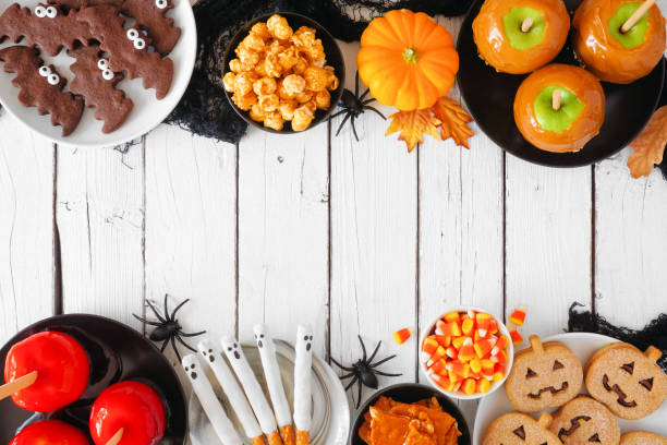istock Rustic Halloween treat double border over a white wood background 1336521009