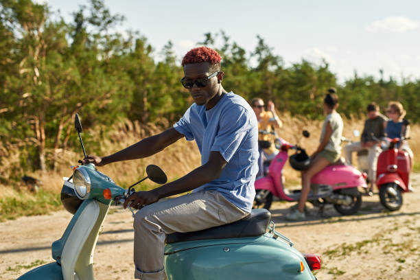 istock Cheerful young african american man on retro scooter 1336521012