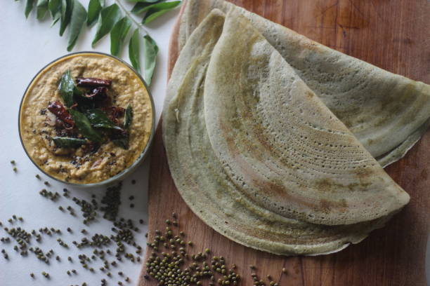 protein rich moong bean crepe, locally known as pesarattu. it looks like dosa but not made with fermented batter - dosa imagens e fotografias de stock