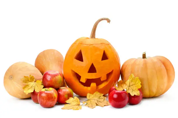 Photo of Pumpkin-head, apples and yellow leaves isolated on white background. Halloween is a fun holiday.