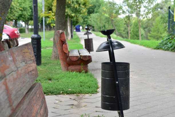 istock The trash can is round between the benches in the park. 1336522592