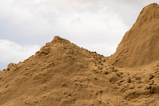 Cloudy with Coarse Sand pile and Find Granular Sand pile and fill Sand pile. used to make concrete  , to create  path , to create  floor. Sand texture , Sand  background and Sand isolated.