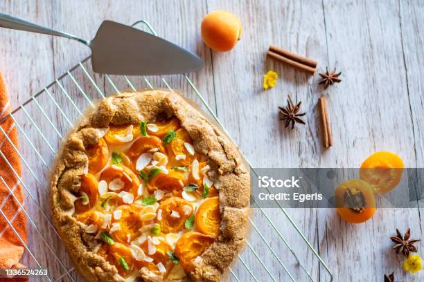 Apricot Galette Pie Cake Placed On Wooden Background With Cooking Tools On The Side Stock Photo - Download Image Now