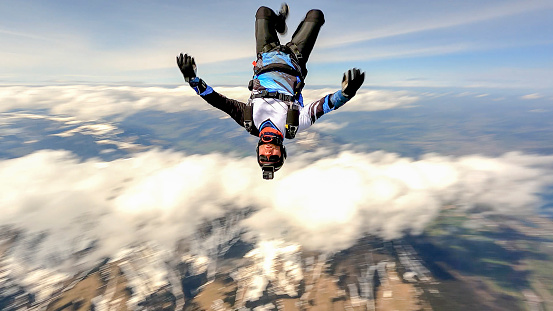 View of skydiver falling through clear skies