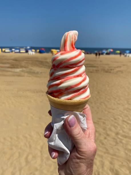 istock Pink ice cream cone on the hot beach 1336524761