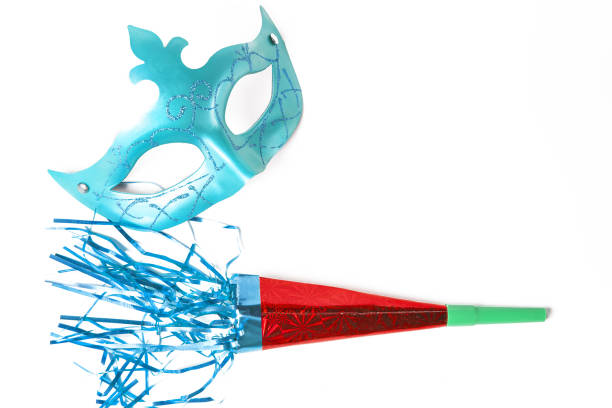 Carnival mask and blower in white background