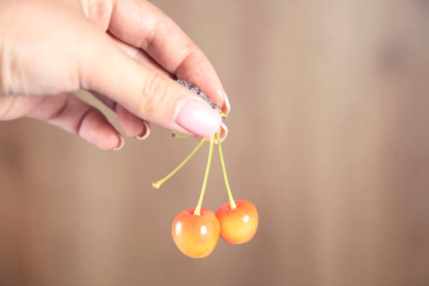 istock woman holding cherries 1336525115