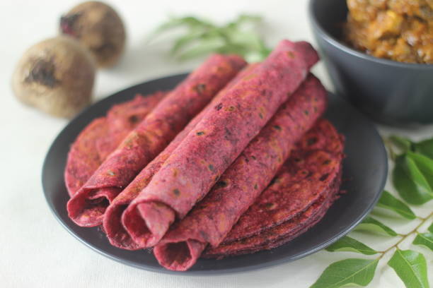 istock Beetroot Paratha is a Indian pan fried whole wheat flatbread made of wheat flour kneaded with fresh grated beetroot and spices. Served with chicken gravy curry. 1336525123
