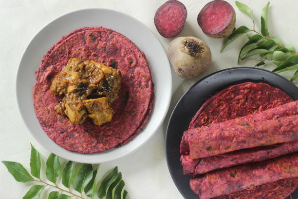 istock Beetroot Paratha is a Indian pan fried whole wheat flatbread made of wheat flour kneaded with fresh grated beetroot and spices. Served with chicken gravy curry. 1336525782