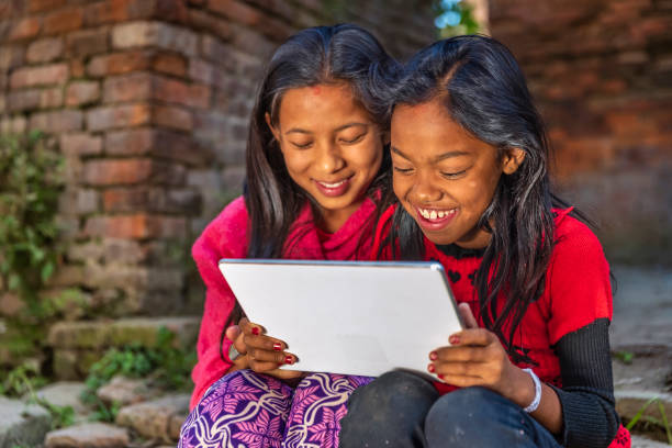 istock Two young Nepali girls using a digital tablet in Bhaktapur, Nepal 1336528401