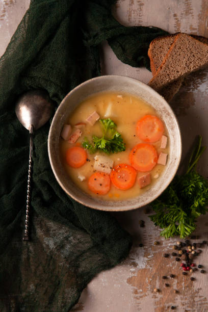 istock Fresh homemade made split pea soup on grey background and dark green kitchen cloth 1336530440
