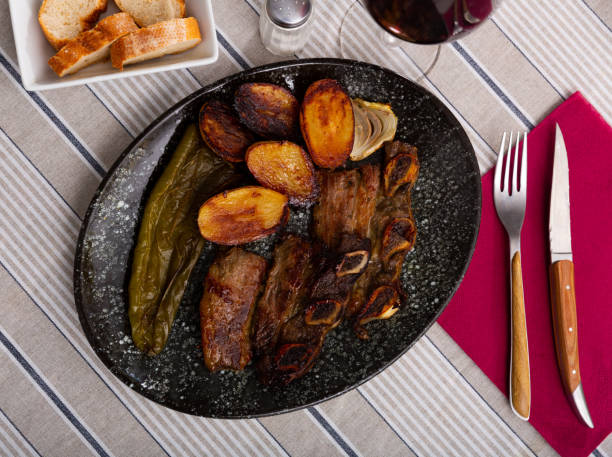 istock Tasty beef baked with potatoes and stewed peppers served 1336530582