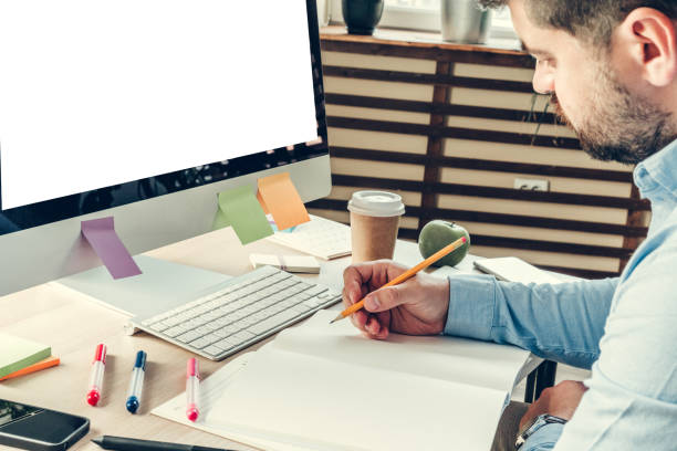 istock Businessman looking at computer monitor during working day in office 1336530803