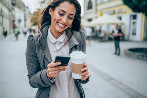 istock Young woman texting on the street. 1336530878